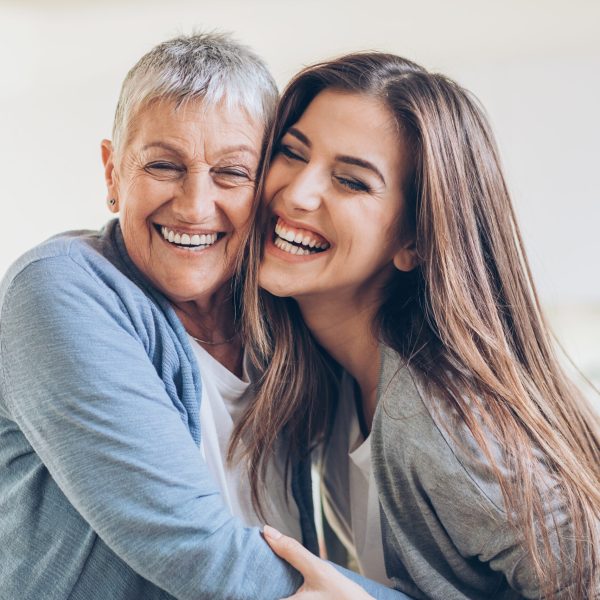 Senior and young women embracing at home