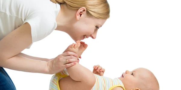 Happy-mother-having-fun-with-her-infant-after-massage-session-at-home