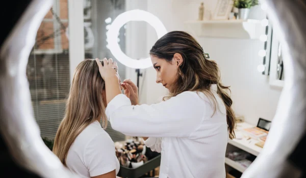 Makeup-process.-Professional-artist-applying-make-up-on-client-face-at-home