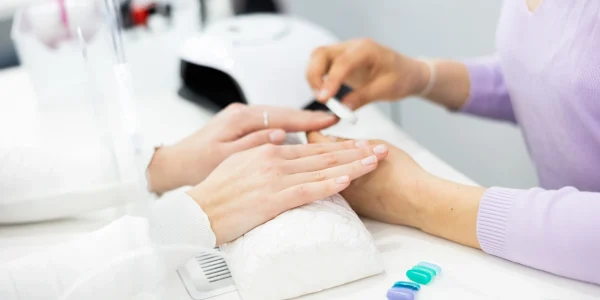 Woman-hands-having-professional-manicure-at-home-shape-to-the-nails-with-a-nail-file