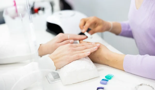 Woman-hands-having-professional-manicure-at-home-shape-to-the-nails-with-a-nail-file