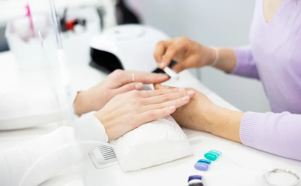 Woman-hands-having-professional-manicure-at-home-shape-to-the-nails-with-a-nail-file